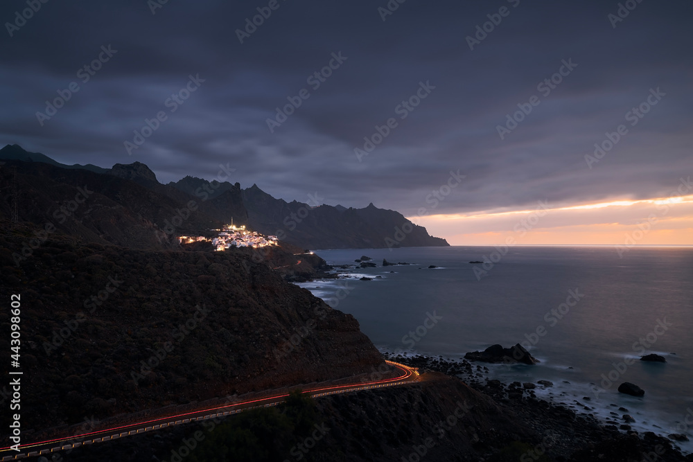 Cliffs in north coastline of Tenerife at moody sunset. Village in Anaga mountains, Tenerife, Canary Islands, Spain. Cliffs in north coastline of Tenerife at moody sunset. Village in Anaga mountains, Tenerife, Canary Islands, Spain.