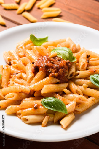 Piatto di deliziose penne rigate condite con ragu di pesce, Cucina Italiana di mare  photo