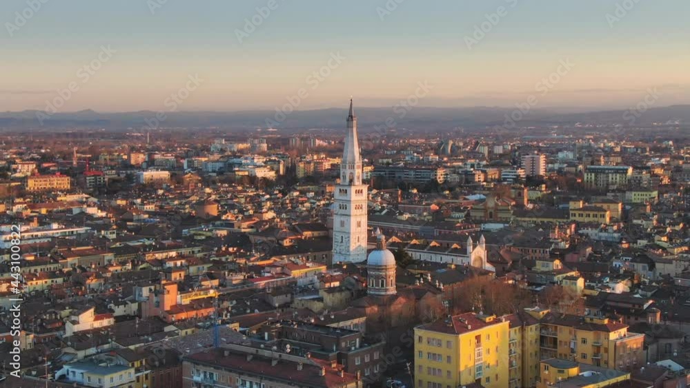 city of modena aerial view at sunset,drone flying backwards over downtown showing ghirlandina bell tower,emilia romagna italy 4k city of modena aerial view at sunset,drone flying backwards over downtown showing ghirlandina bell tower,emilia romagna italy 4k