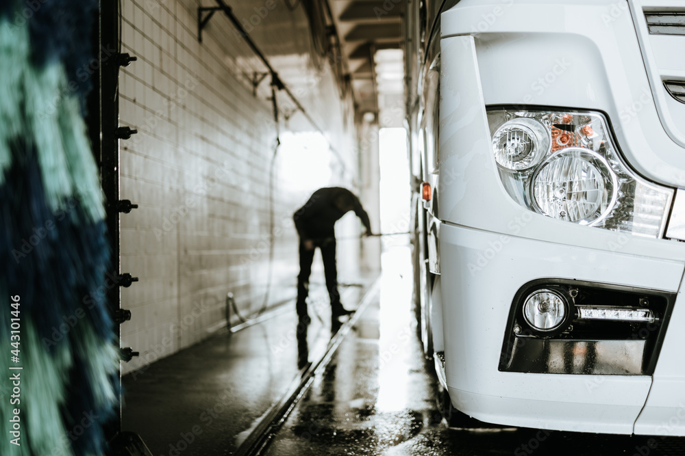 Big truck washing and cleaning at automatic car wash service or station