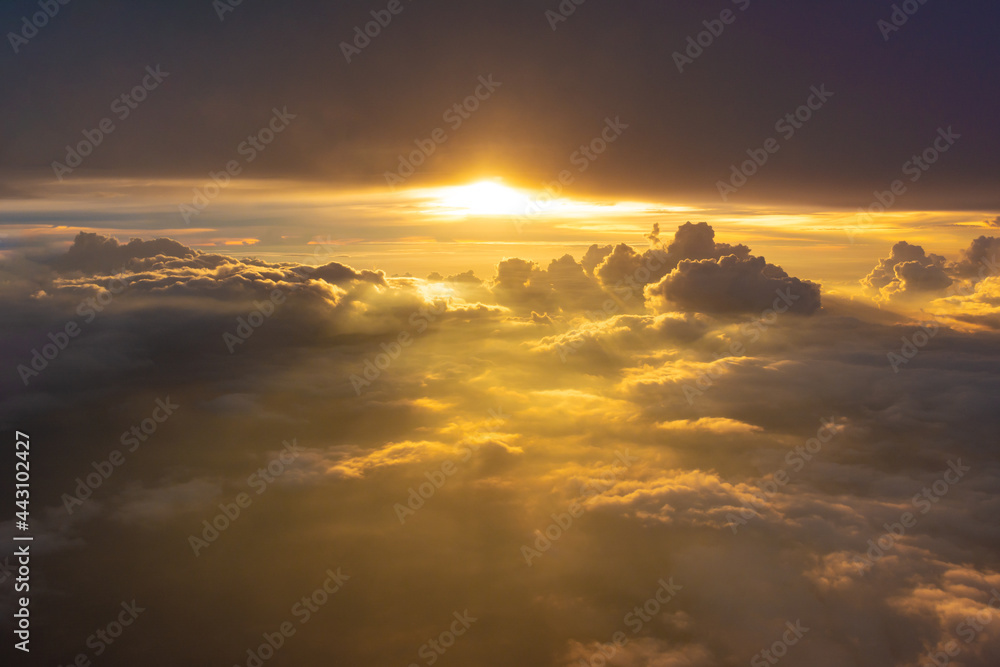 Beautiful dramatic bird eye view of cloudscape with sunset as seen from a plane