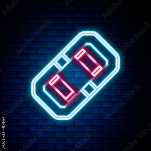 Glowing neon line Rafting boat icon isolated on brick wall background. Inflatable boat. Water sports, extreme sports, holiday, vacation, team building. Colorful outline concept. Vector