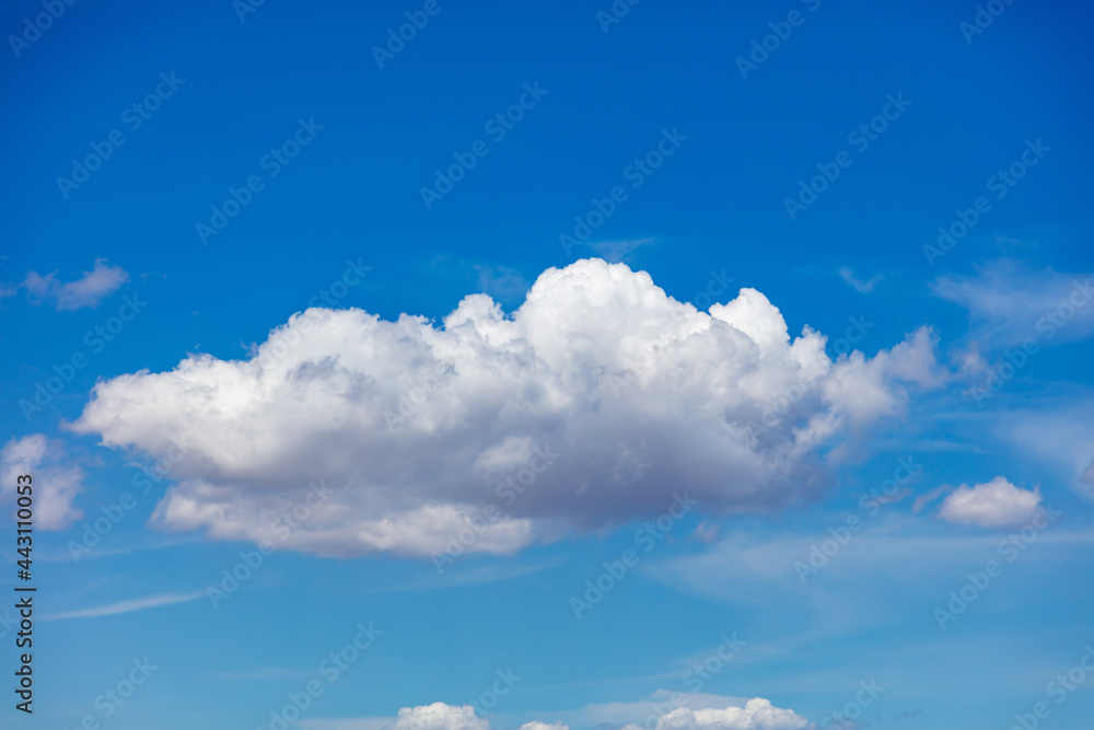 Cloud, fluffy white and grey color on clear blue sky, sunny spring day.