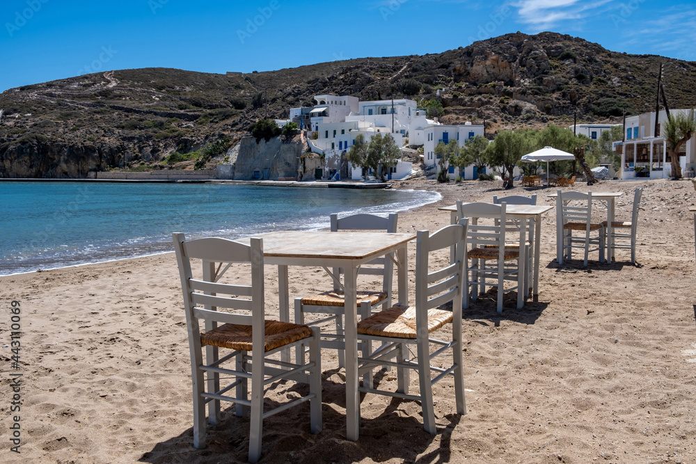 Greek island outdoor tavern table by the sea, sunny day