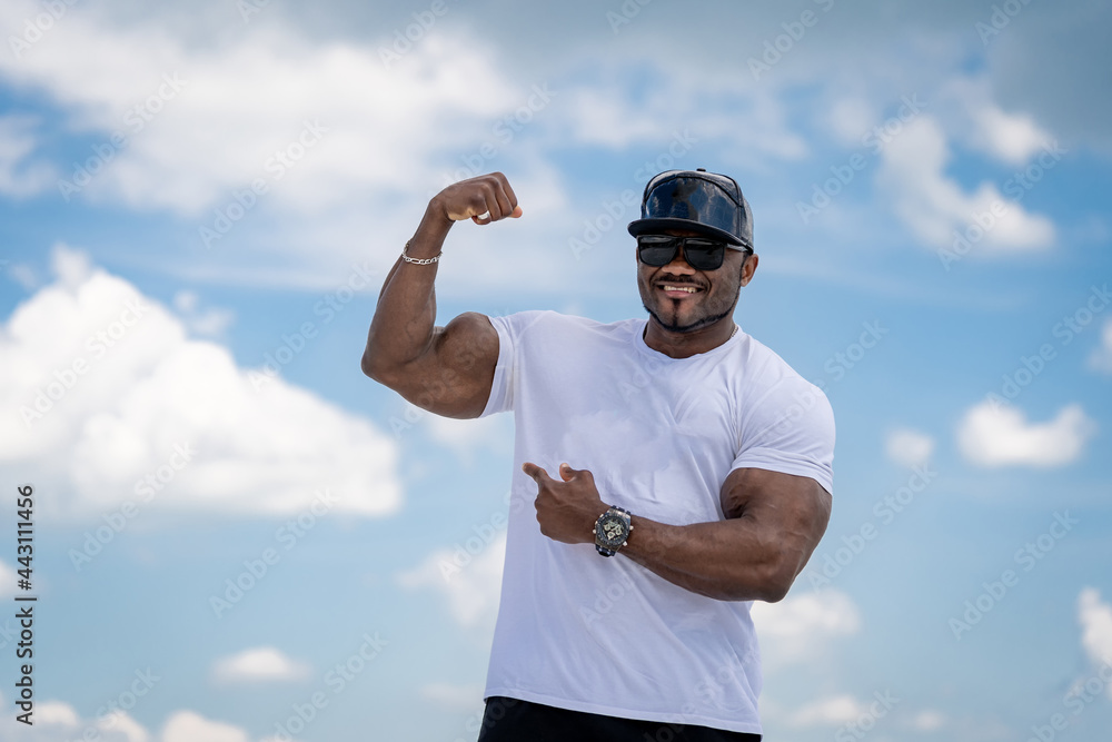 Handsome athletic man showing his muscles. Strong fit bodybuilder showing his biceps. Handsome athletic man showing his muscles. Strong fit bodybuilder showing his biceps.