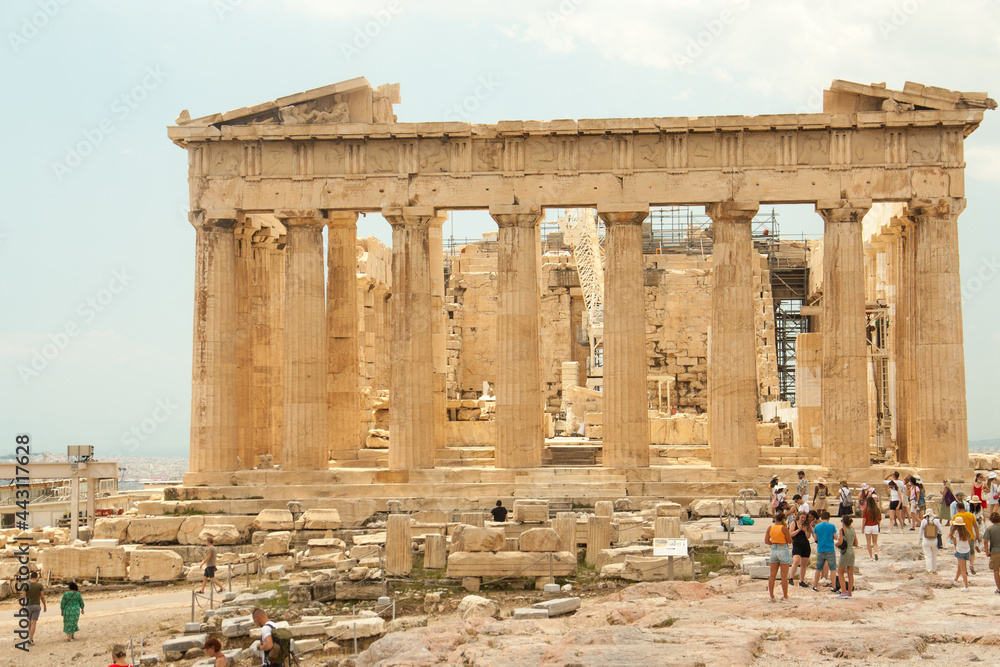 Parthenon temple with tourists on the Acropolis in Athens, Greece in sunny summer day