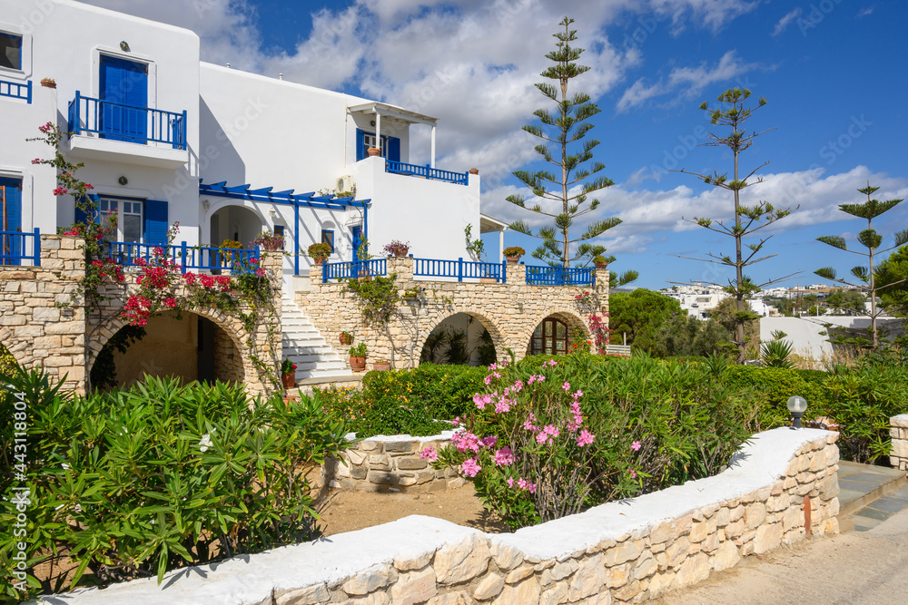Typical whitewashed Greek villa with blue windows in the Cycladic style on Paros island. Greece