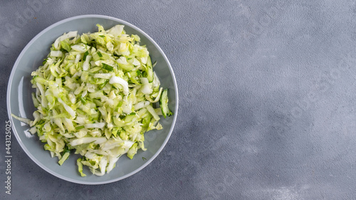 Healthy salad with fresh cabbage and cucumber. Copy space, top view