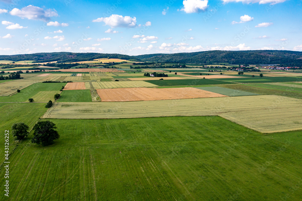 The landscape of the Werra Valley with the Werra River and agriculture fields at Herleshausen in Hesse and Thuringia