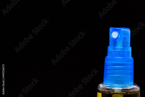 Close up shot of blue spray nozzle dispenser in black background. with space for free text photo