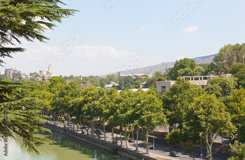 Tbilisi, Georgia-August 07, 2013: Embankment of the Mtkvari river and historic Sololaki district in Tbilisi. Summer day