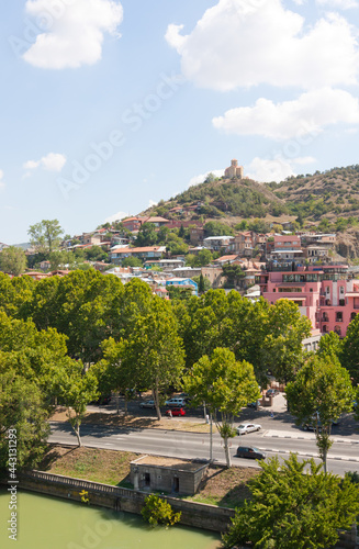 Tbilisi, Georgia-August 07, 2013: Embankment of the Mtkvari river and historic Sololaki district in Tbilisi. Summer day