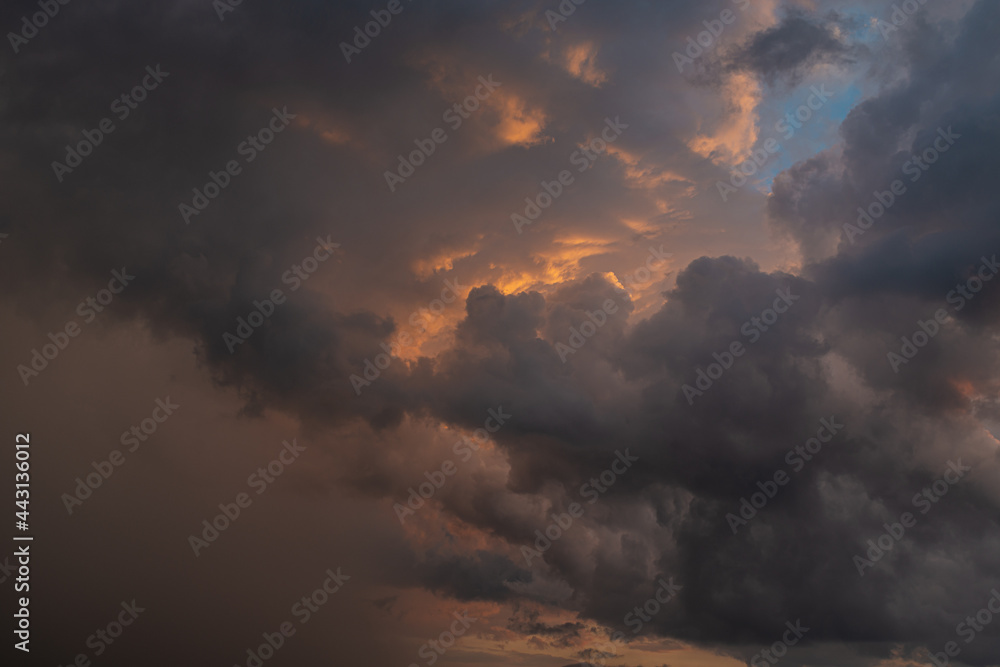 a dark thundercloud on the background of sunset a dark thundercloud on the background of sunset