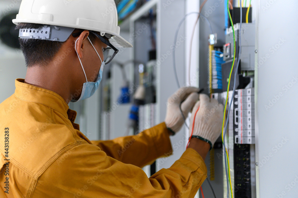 Electrician engineer using digital multimeter test current electric in control panel for testing electrical installations and wiring work in power control room on new building. Electrician engineer using digital multimeter test current electric in control panel for testing electrical installations and wiring work in power control room on new building.