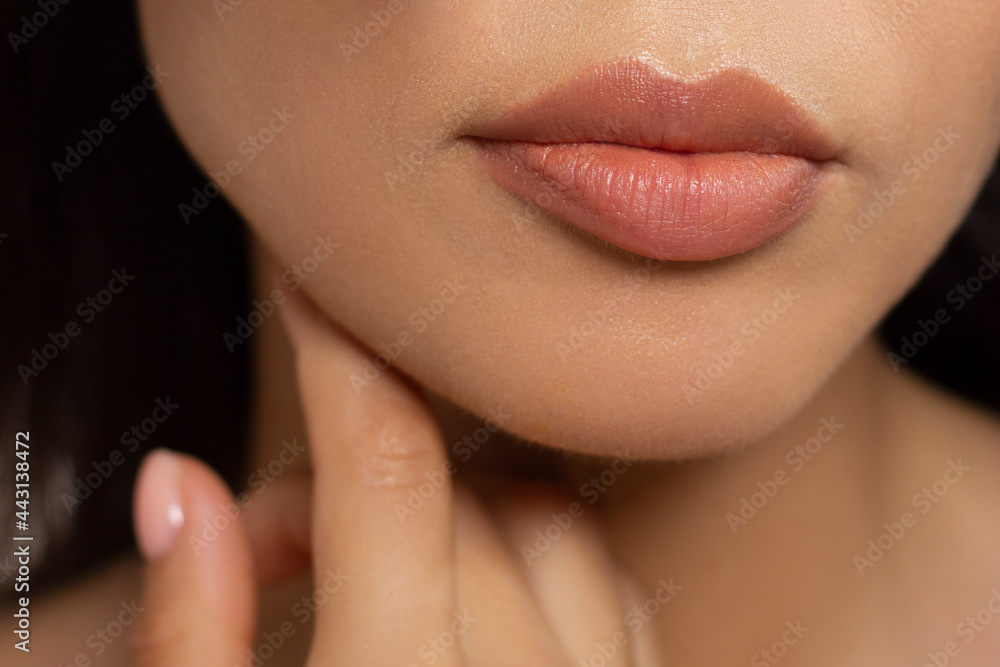 Fototapeta premium Closeup plump Lips. Lip Care, Augmentation, Fillers. Macro photo with Face detail. Natural shape with perfect contour. Close-up perfect natural lip makeup beautiful female mouth. Plump sexy full lips