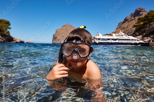 Little boy enjoying snorkeling on summer holiday. photo