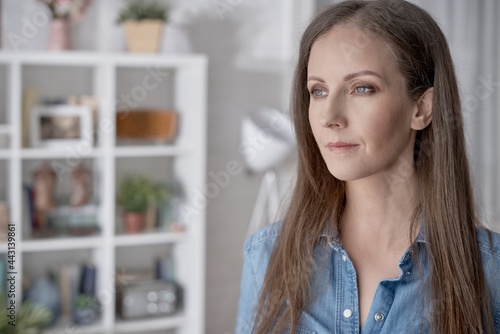 Portrait of young woman at home with happy confident smile.