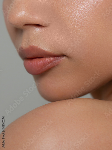 Sexual full lips. Natural gloss of lips and woman's skin. The mouth is closed. Increase in lips, cosmetology. Natural lips. Great summer mood with open eyes. fashion jewelry. Pink lip gloss