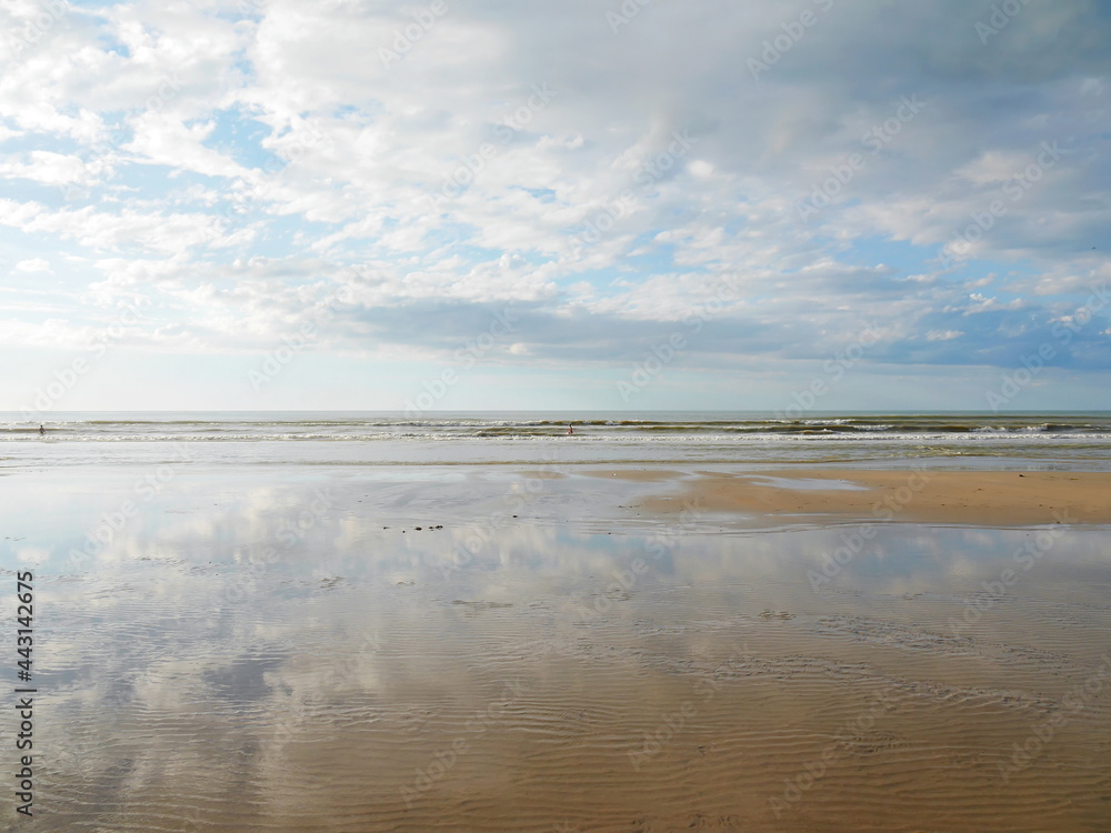 Panoramic view to ocean during low tide of ocean, clouds reflection, Dieppe, France