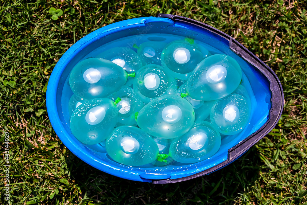 Blue bucket full of water balloons Blue bucket full of water balloons