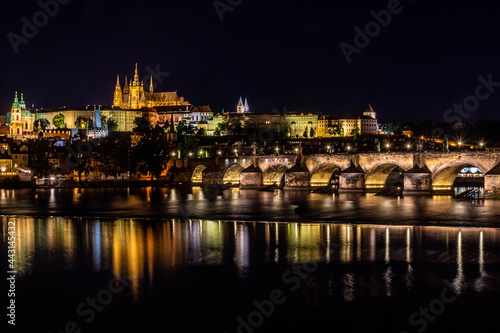 PRAGUE, CZECH REPUBLIC, 31 JULY 2020: beautiful reflection of the Castle of Prague and the Charles Bridge at night