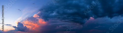 Dramatic sunset sky with dark stormy clouds.