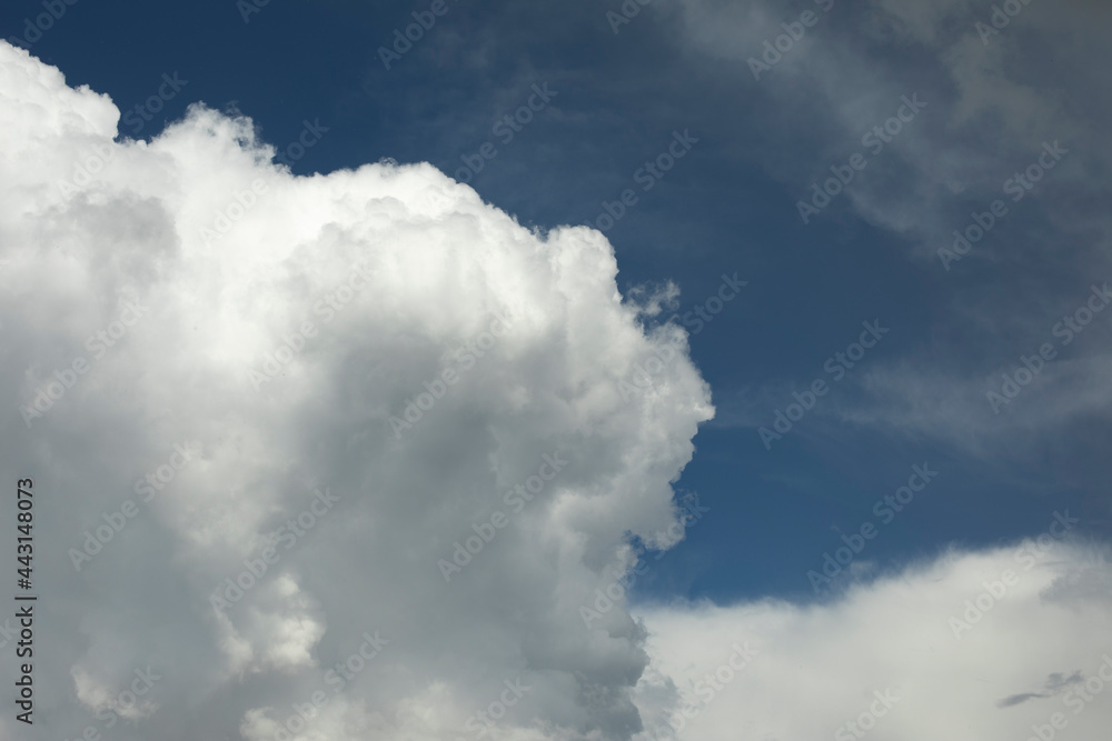 White clouds in the sky. Cumulus clouds against the blue sky. White clouds in the sky. Cumulus clouds against the blue sky.