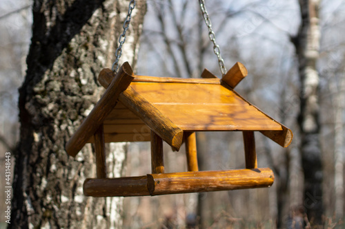 A bird house. A wooden birdhouse on a tree.