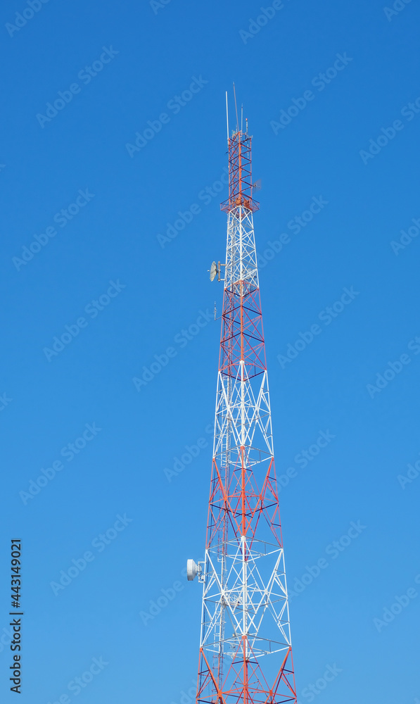 Tall towers transmit radio and telephone signals and various communications, internet, wifi signal system with blue sky background Tall towers transmit radio and telephone signals and various communications, internet, wifi signal system with blue sky background