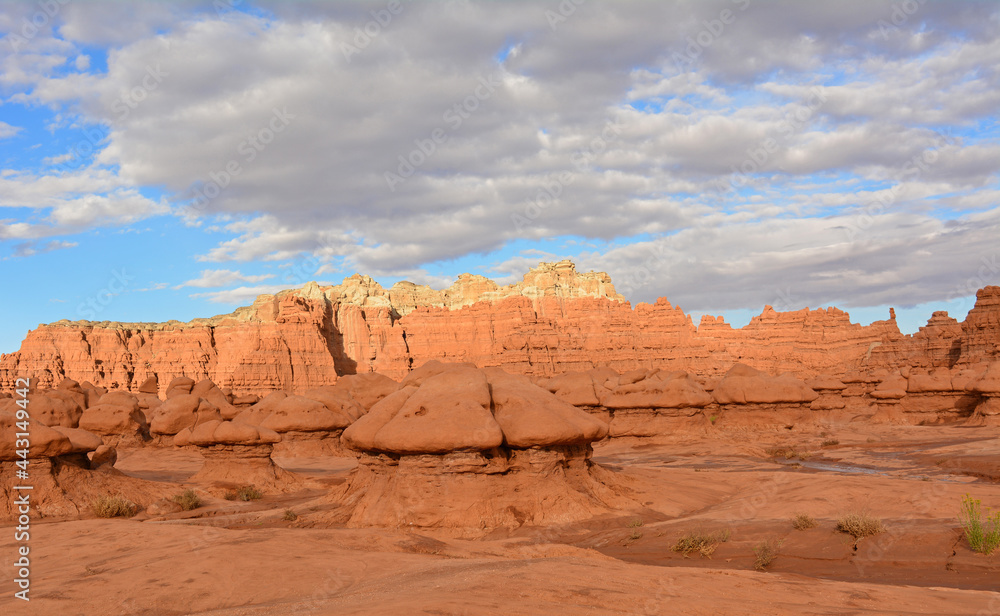 Arid wash, colorful peaks, and     Bizarre hoodoos at dusk  in goblin valley state park, utah      