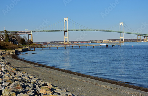 Looking out at  the Claiborne pell newport  bridge to newport from the beach on conanicut island, Rhode Island, on a sunny spring day photo