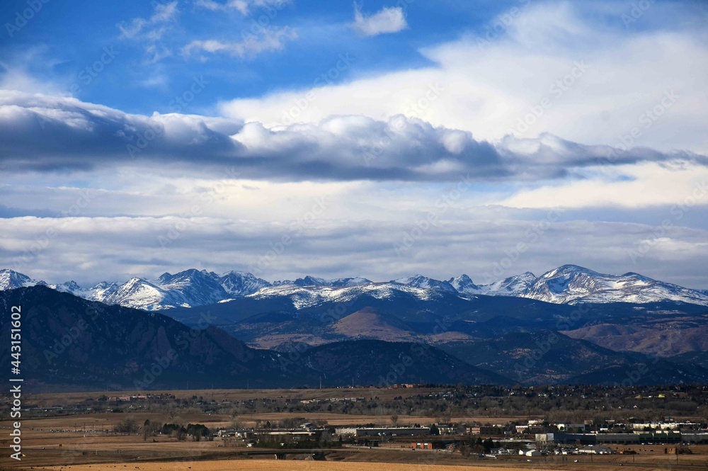 panoramic view from broomfield of the front range mountains of colorado, and dramatic 
cloud patterns