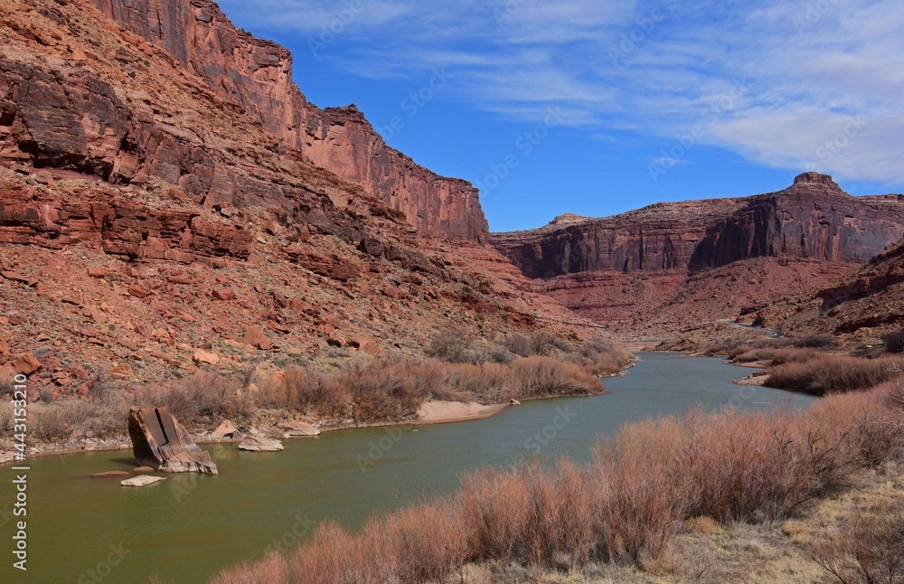 eroded red rock  canyon walls on a sunny day   along the scenic colorado river  north of moab,  utah