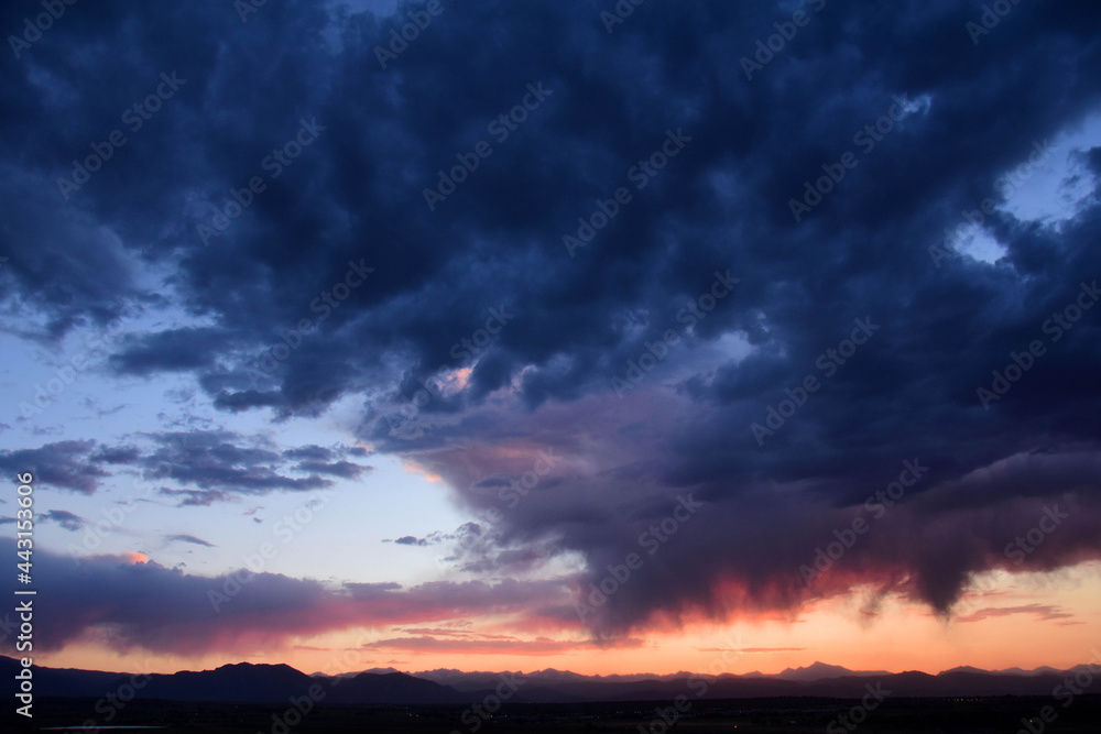 Dramatic sunset and Virga clouds over the front range of the Rocky Mountains, as seen from Broomfield, Colorado 