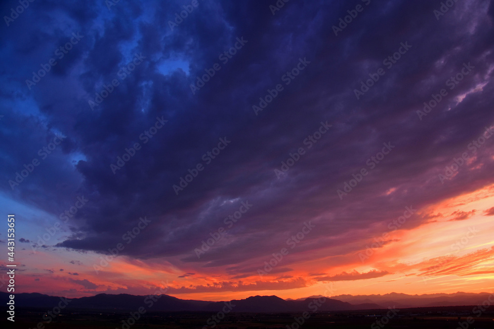 colorful purple-hued sunset over the front range of the colorado rocky mountains, as seen from broomfield,colorado
