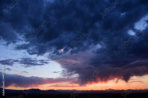 Dramatic sunset and Virga clouds over the front range of the Rocky Mountains, as seen from Broomfield, Colorado 