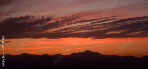 colorful  sunset over long s peak in the front range of the colorado rocky mountains  as seen from broomfield colorado