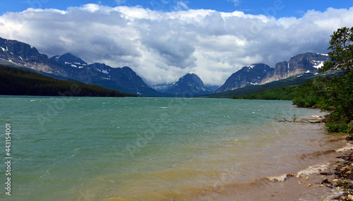 the turquoise-colored water of lake sherburne and   beautiful glaciated peaks of glacier national park, montana    photo