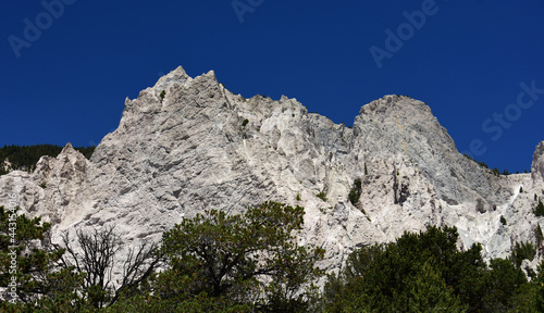 rugged Chalk cliffs and pinyon pines on a sunny summer day  along  tin cup pass road, near nathrop, Colorado  photo