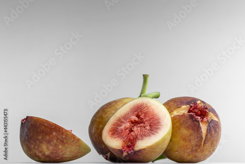 White background photo of figs cut in half.