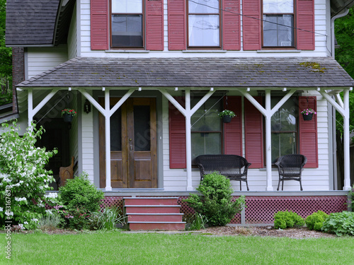 Large old fashioned porch of rural house  with wicker chairs