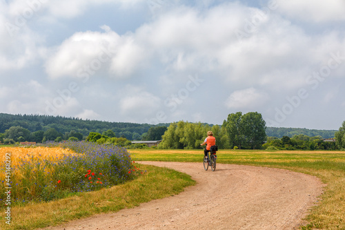 Radfahrerin auf dem Feldweg, Mecklenburg-Vorpommern,, Deutschland, Europa © artfocus