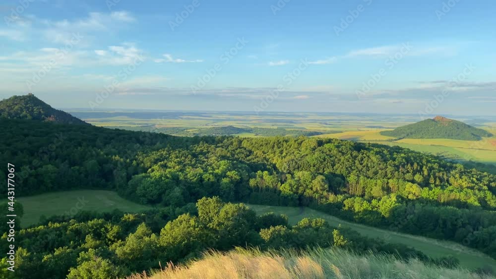 Sunrise in Central Bohemian Highlands.It is a mountain range located in northern Bohemia in the Czech Republic.The range is about 80 km long, extending from Ceska Lipa in the northeast to Louny. Sunrise in Central Bohemian Highlands.It is a mountain range located in northern Bohemia in the Czech Republic.The range is about 80 km long, extending from Ceska Lipa in the northeast to Louny.