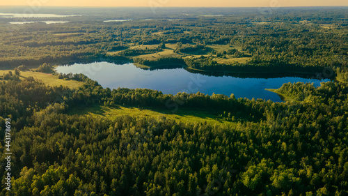 Incredibly beautiful aerial view landscape: green forest, fields, trees, lake. Wonderful sunset. Desktop wallpaper © Vladislav