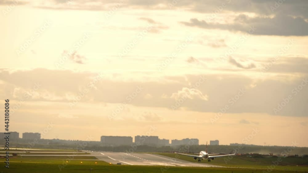 Slow plane landing in golden sunset Slow plane landing in golden sunset