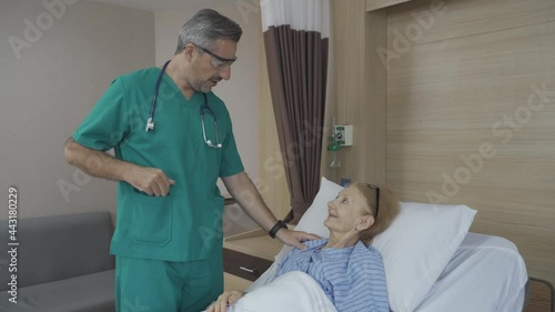 Doctor checking on old lady patient