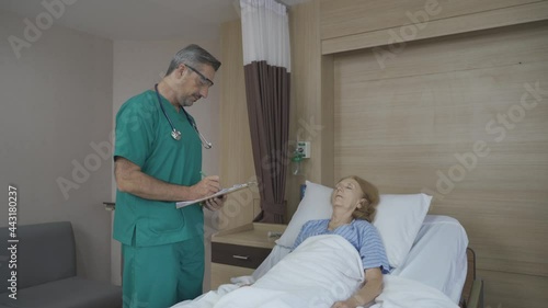 Doctor taking note while patient sleep