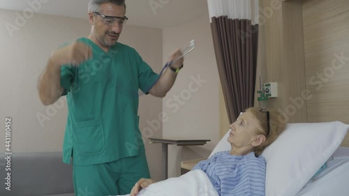 Doctor checking old lady patient's pulse