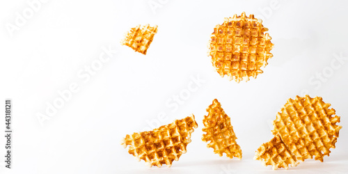 Belgian traditional waffles, creative composition on a light background. Minimalism style, selective focus, copy space. Sweet food, banner size.
