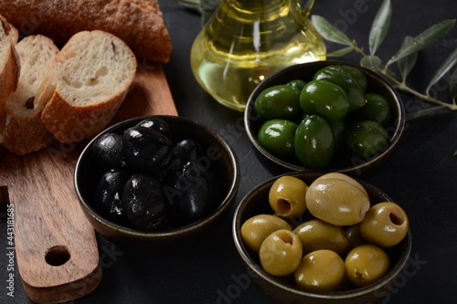 Olives, olive branch ,Olive oil on wooden background